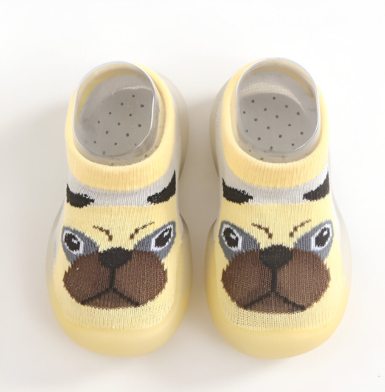 Yellow baby shoes with pugs